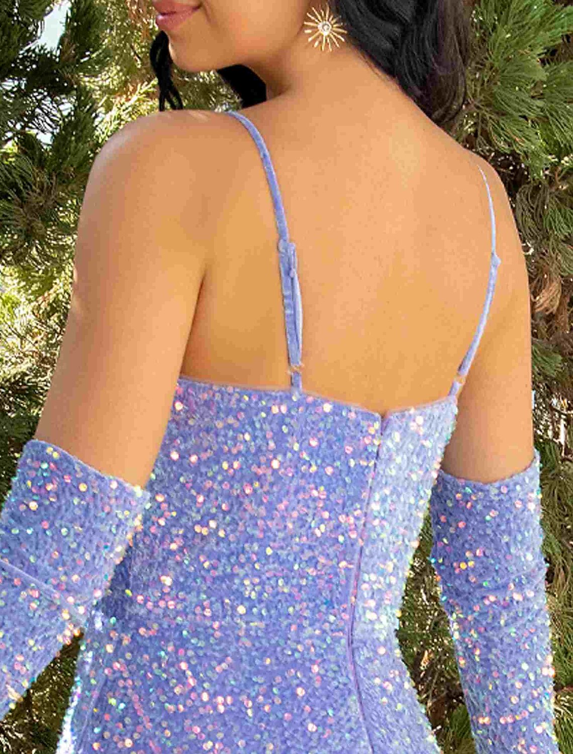Close-up of sequin detailing and pleats on the dress fabric.