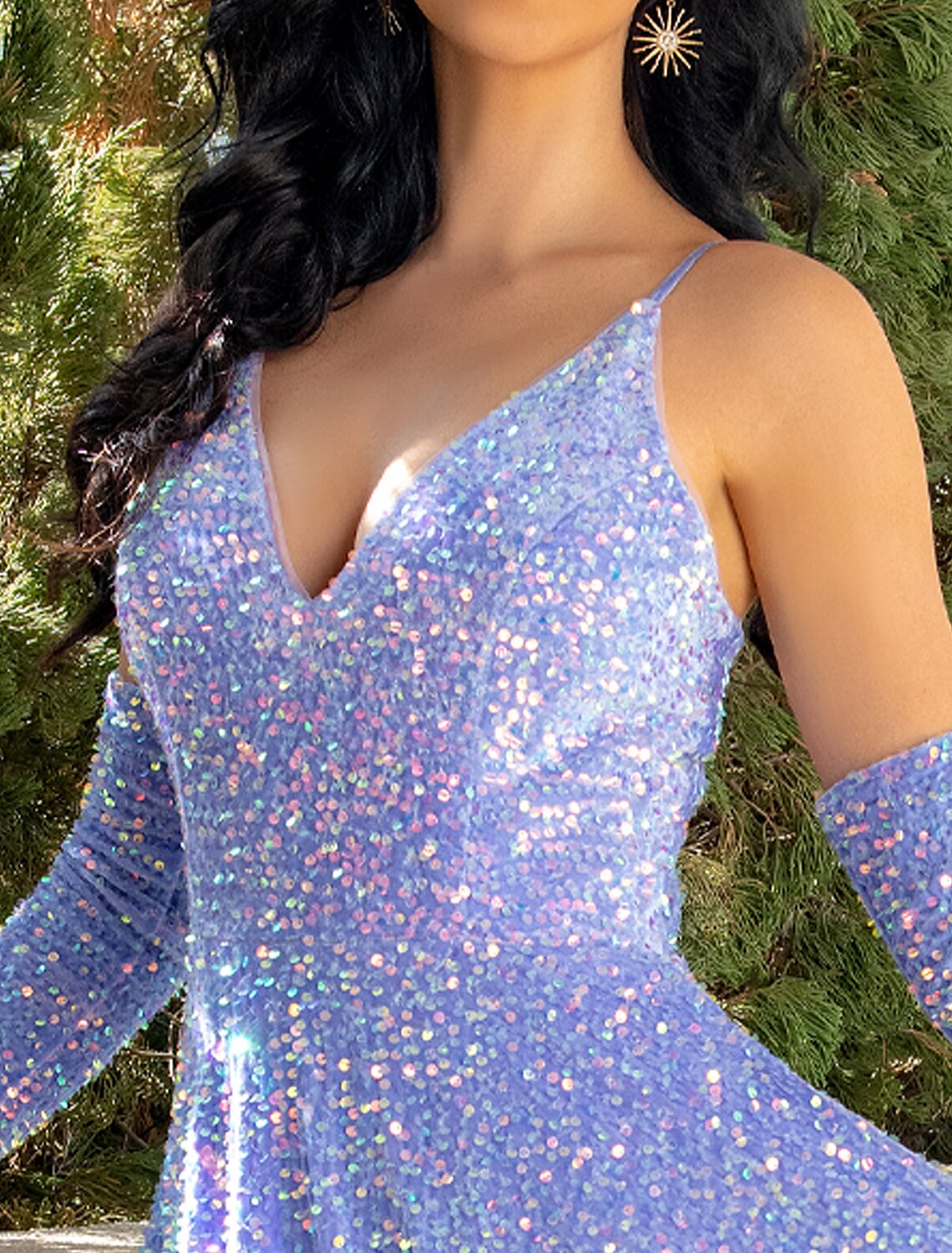 Model posing gracefully in a shimmering A-line sequined gown.