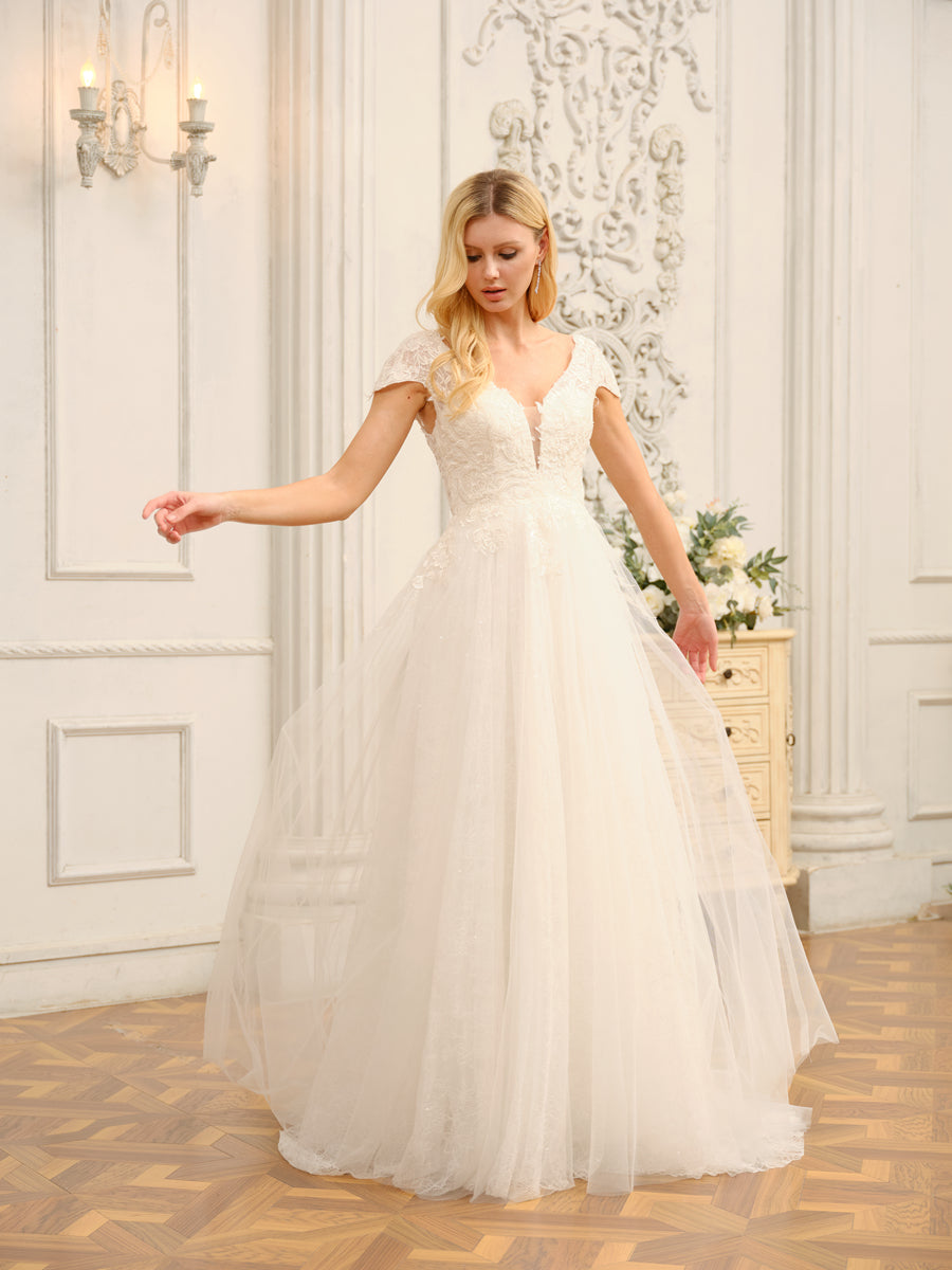 Close-up of the V-neckline and short sleeves on the bridal dress.