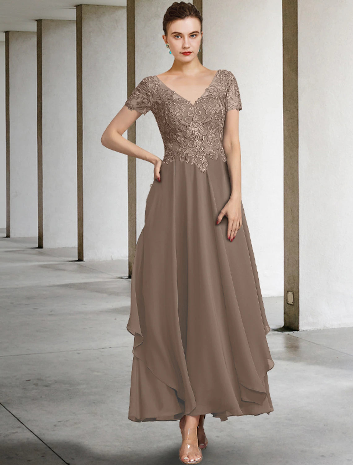 Close-up of the V-neckline and short sleeves with intricate lace appliques on the Mother of the Bride dress.