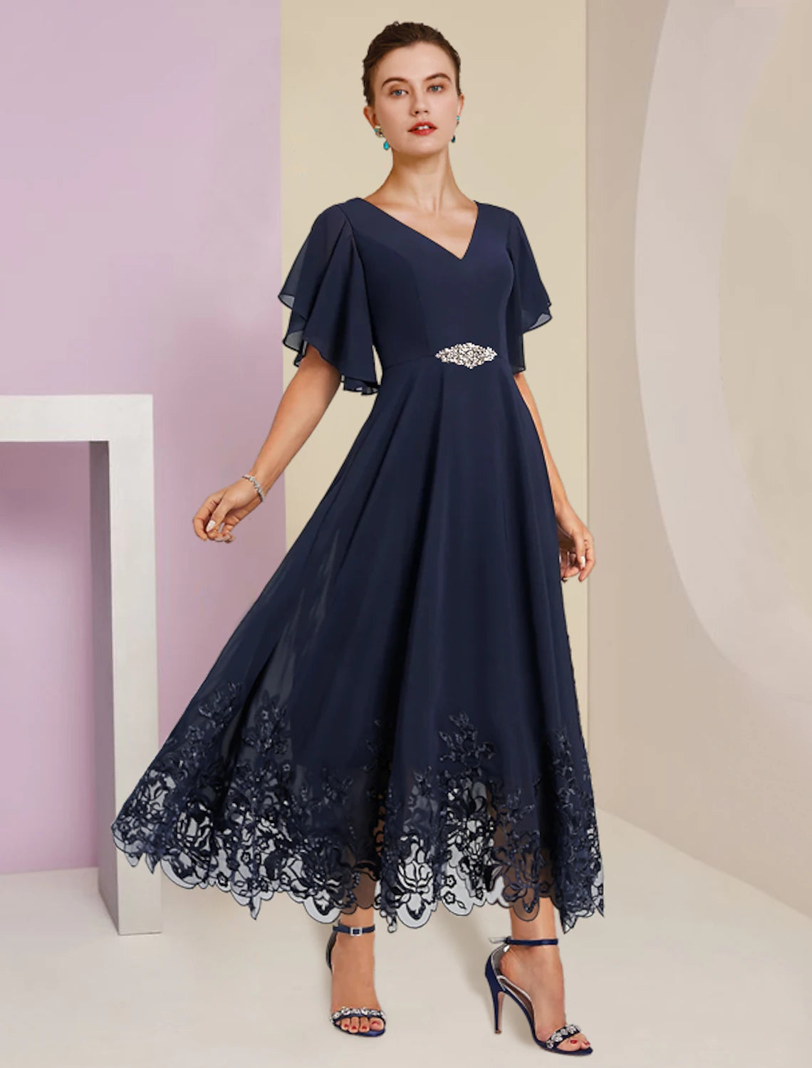 Elegant A-line V-neck tea length mother of the bride dress with short sleeves and lace appliques.