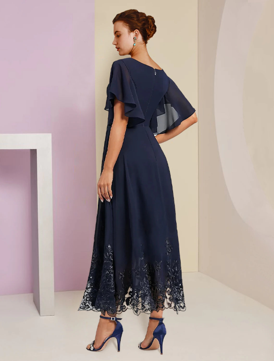 Back view of the A-line chiffon lace dress, showing the elegant silhouette and detailing.