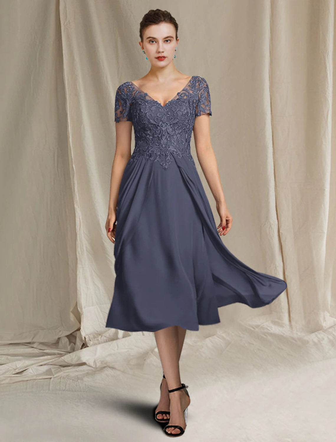 Side profile of a woman showcasing the tea-length A-line mother of the bride dress.