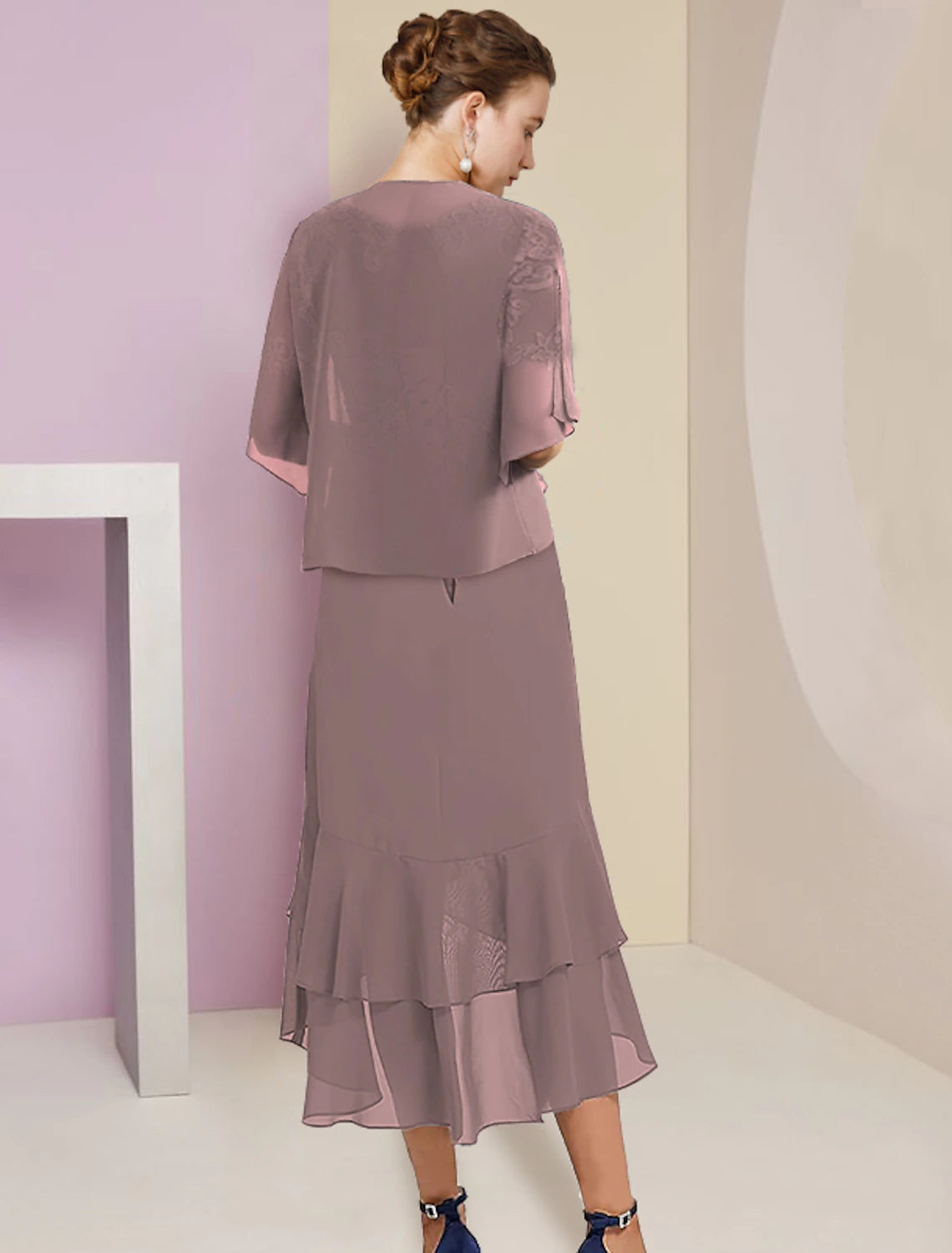 Back view of two-piece A-line dress showing lace appliques and tea length skirt.