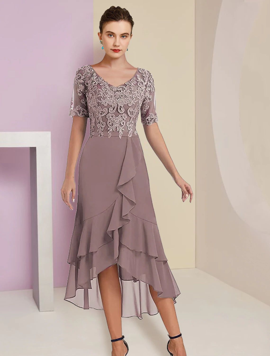 Close-up of V-neckline and short sleeve with lace details on the dress.