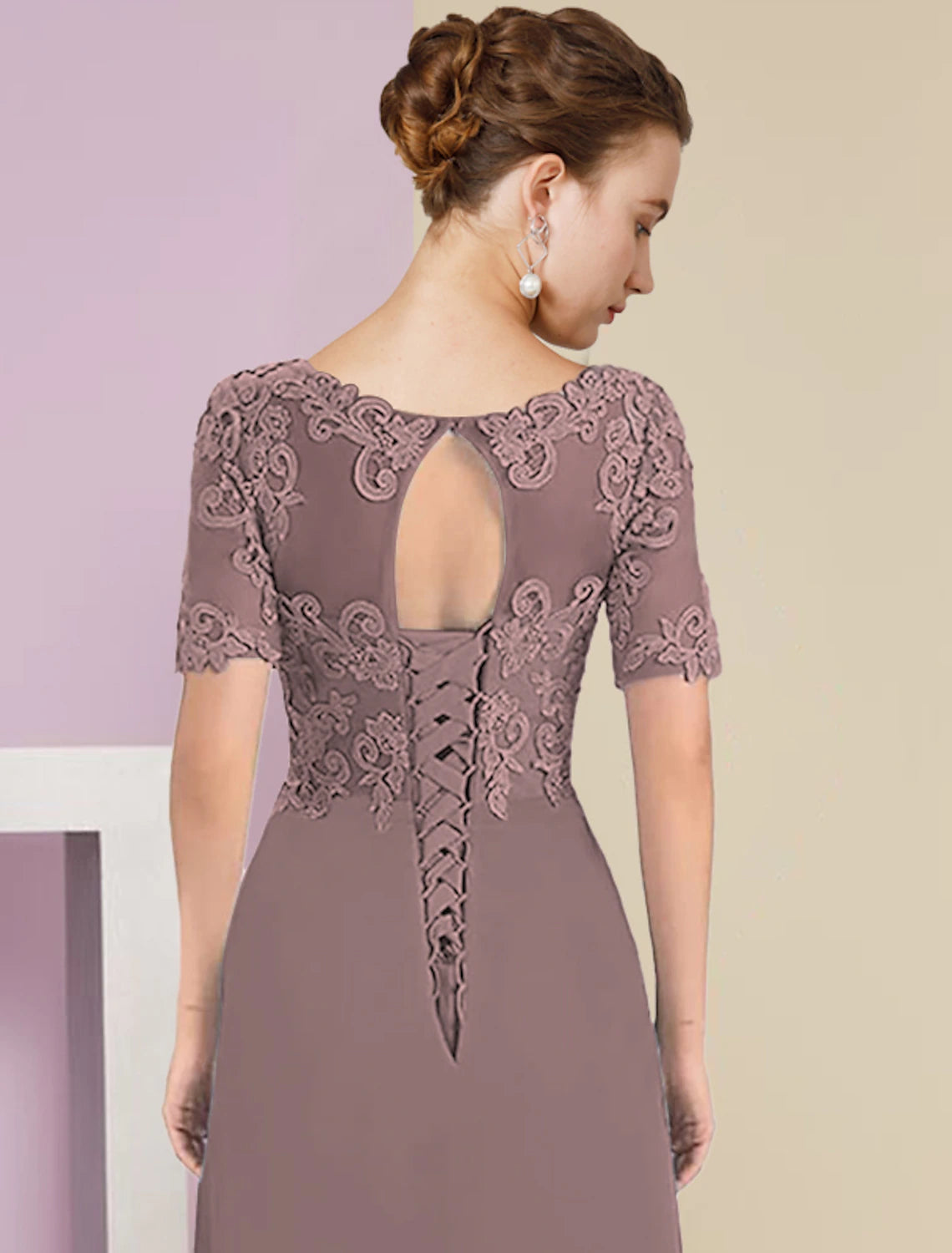 Model posing gracefully in the elegant mother of the bride dress.