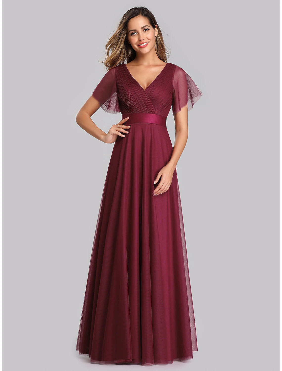 Model wearing a light blue A-line chiffon evening gown with V-neck and short sleeves.