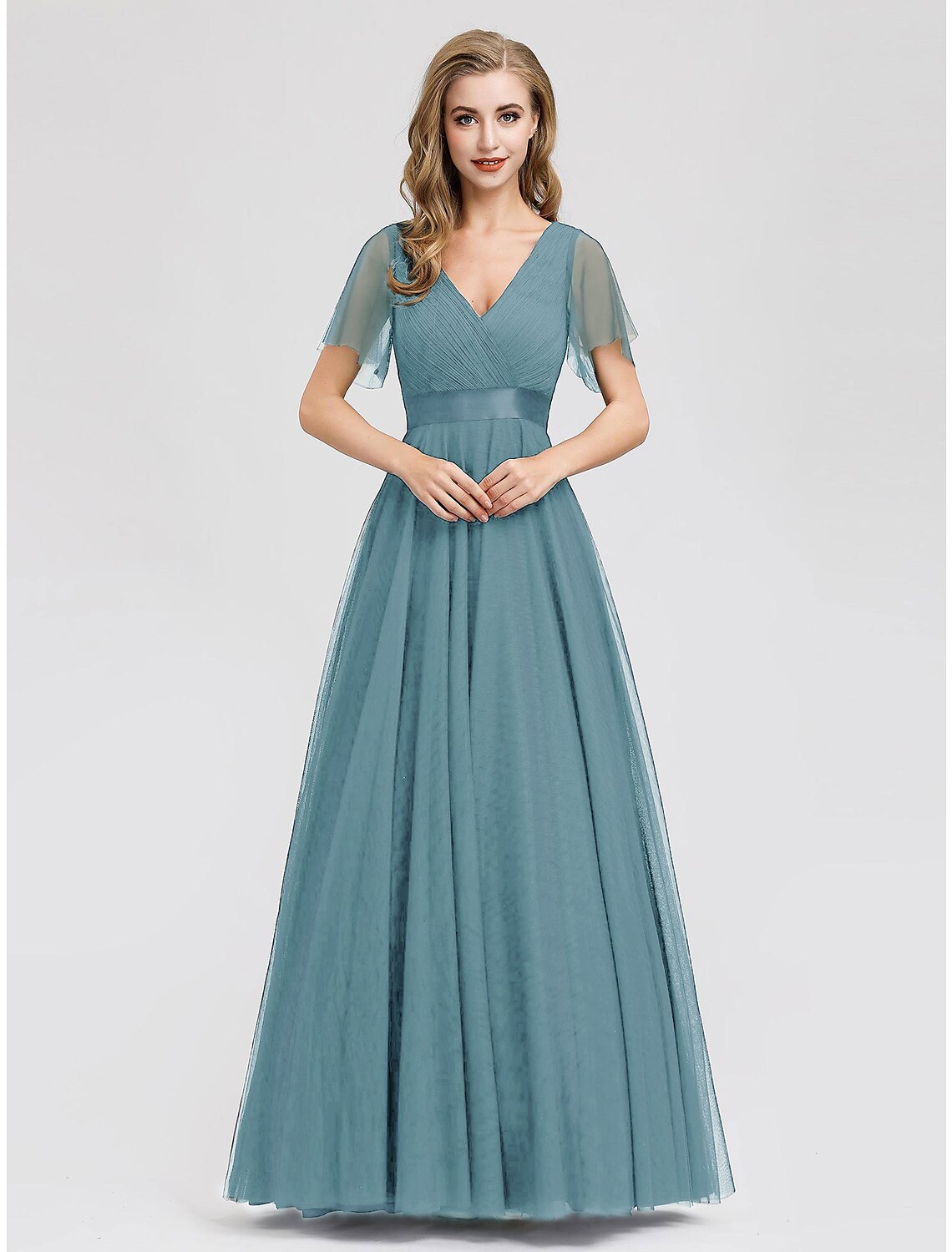 Model in a purple A-line chiffon prom dress with short sleeves and empire waist.
