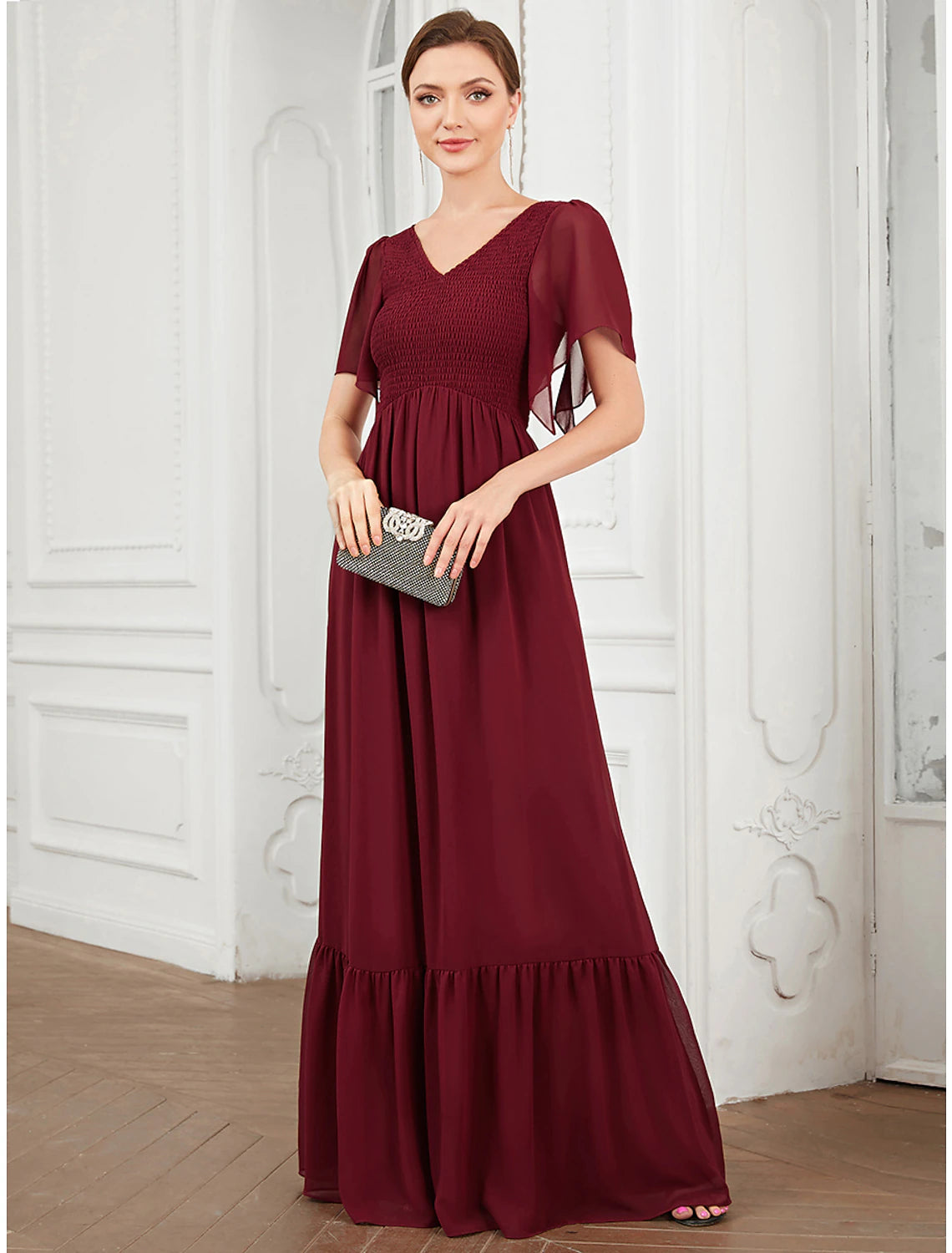 Woman wearing a blue Weitese A-line V-neck short-sleeve chiffon prom dress with pleats.