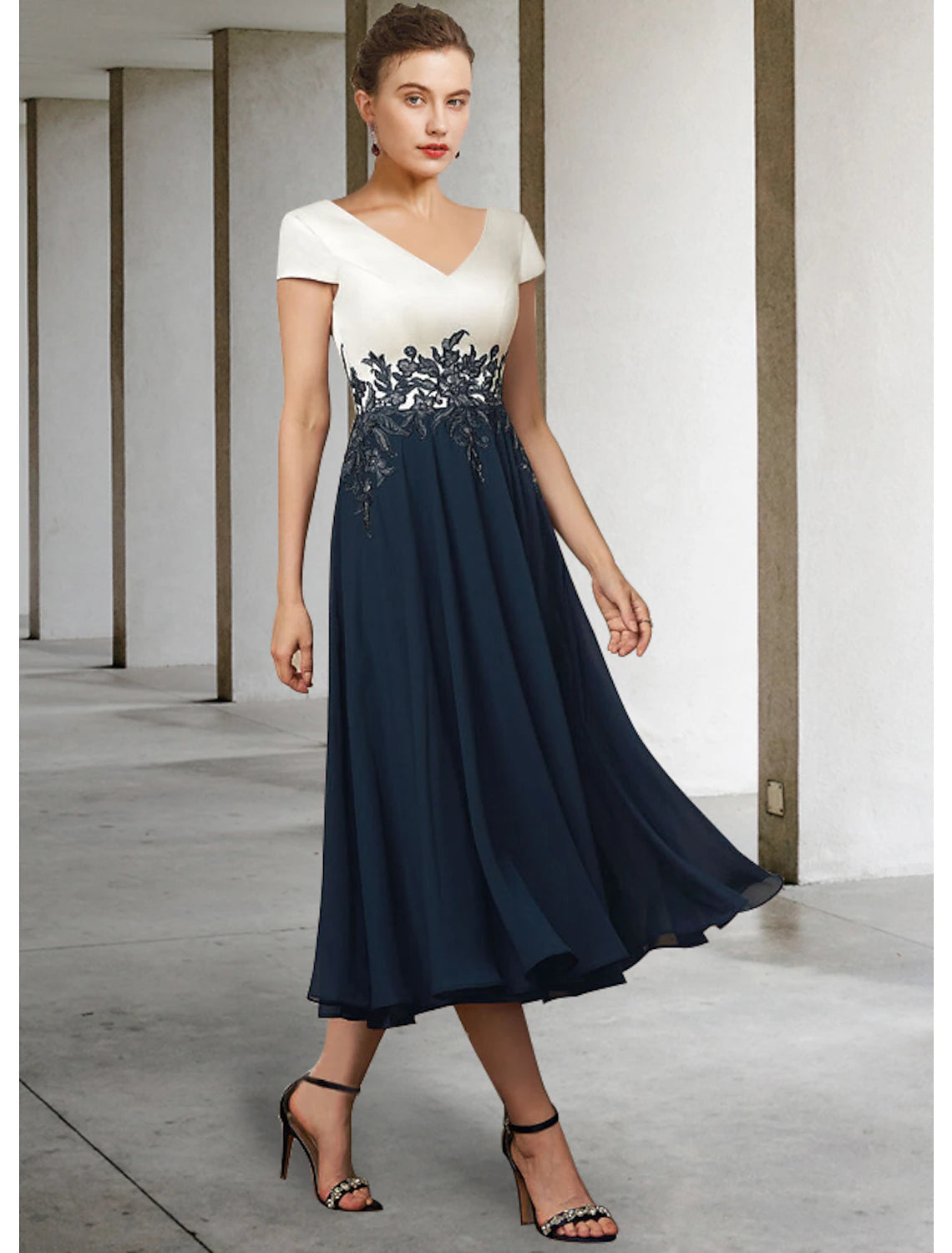 Back view of the Weitese A-line tea-length dress, highlighting pleats and elegant silhouette.