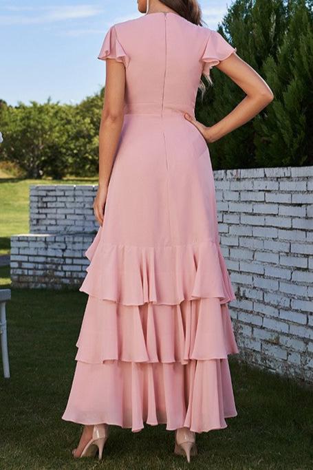 Side view of a model in a light blue A-line chiffon bridesmaid dress, showing ruched bodice detail.
