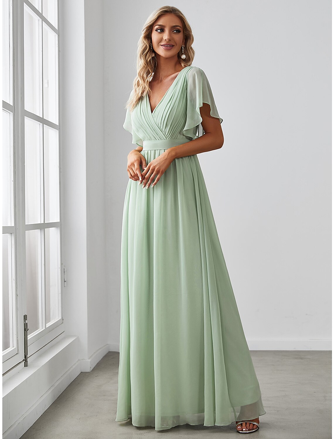 Full-length view of a model posing in the elegant A-line bridesmaid dress.