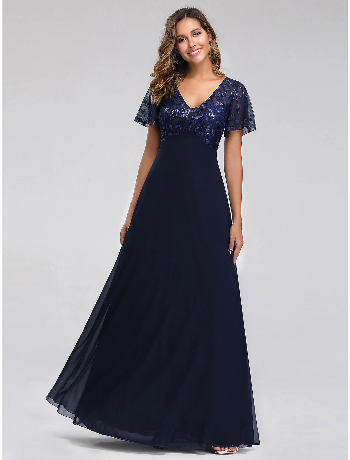Model wearing an elegant A-line V-neck short sleeve sequin tulle floor-length dress.