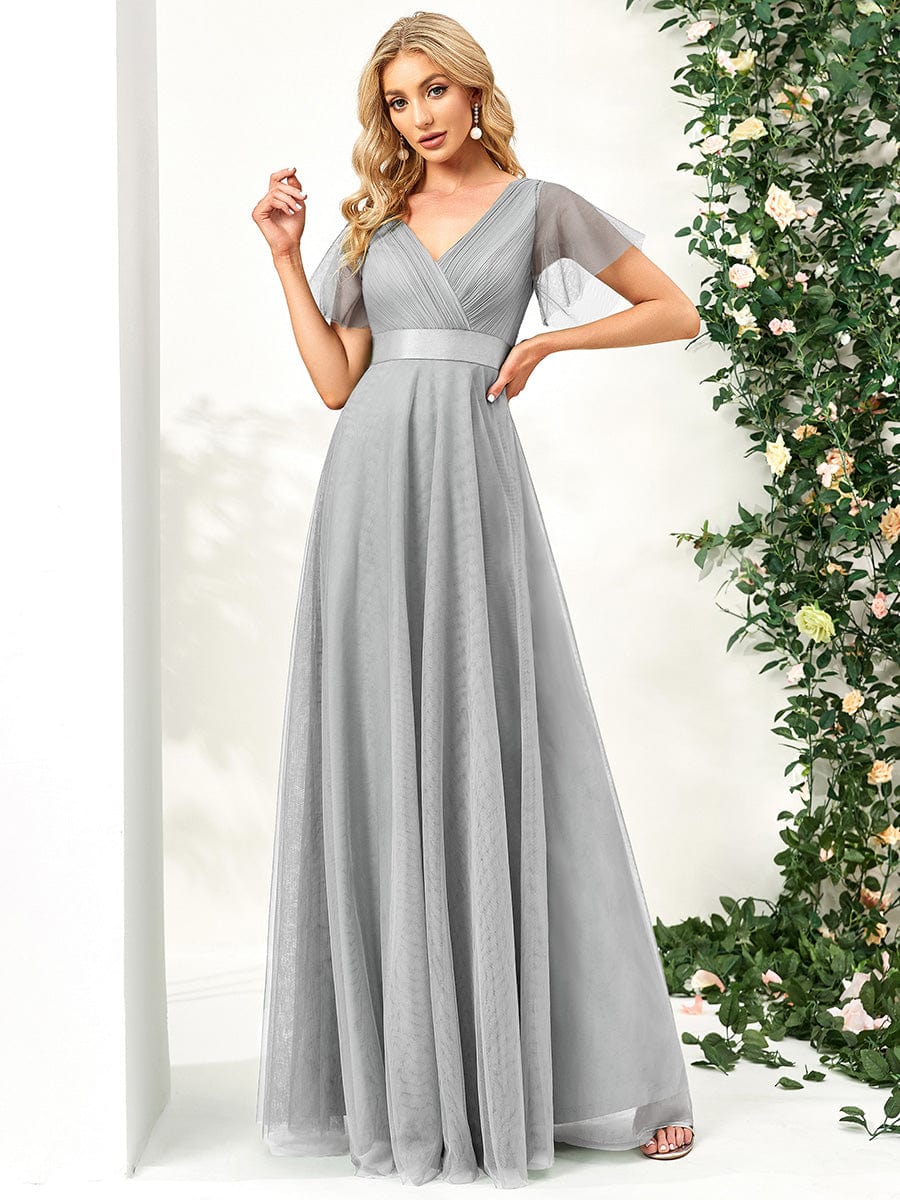 Model wearing a grey V-neck short sleeve tulle dress.