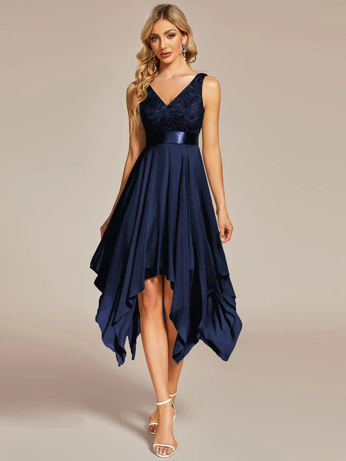 Woman wearing a red V-neck lace party dress with an asymmetrical hem.