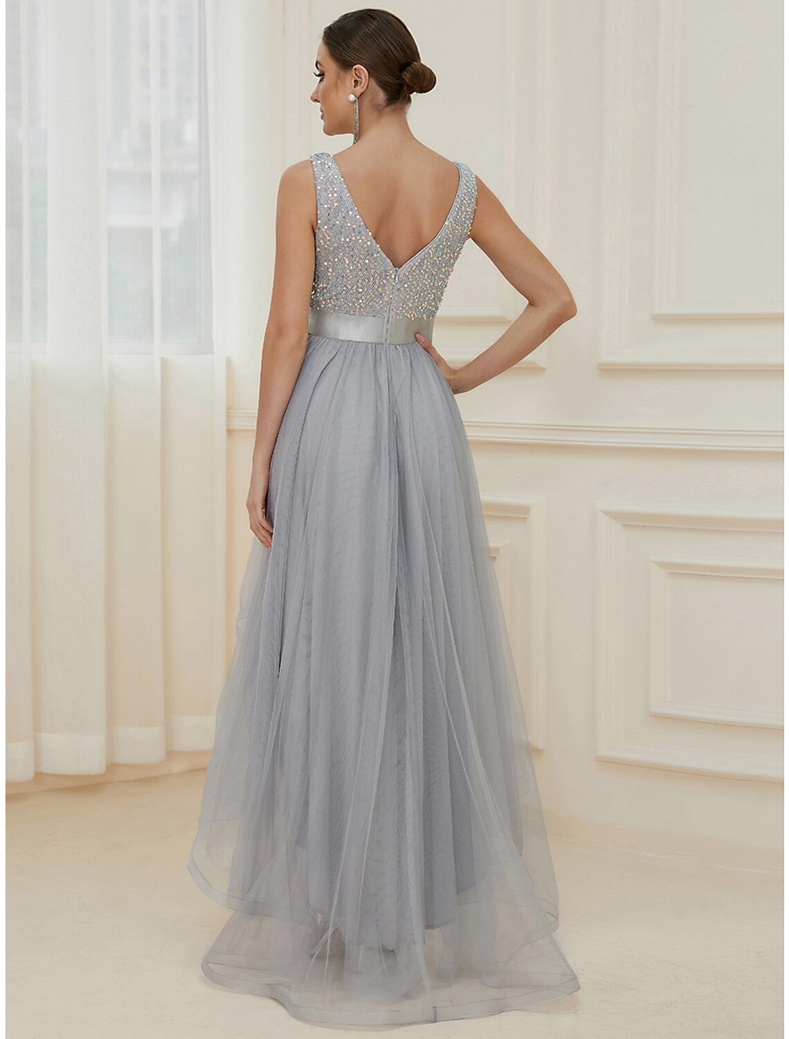 Side view of the sequined asymmetrical A-line bridesmaid dress, showing the V-neck and sleeveless design.