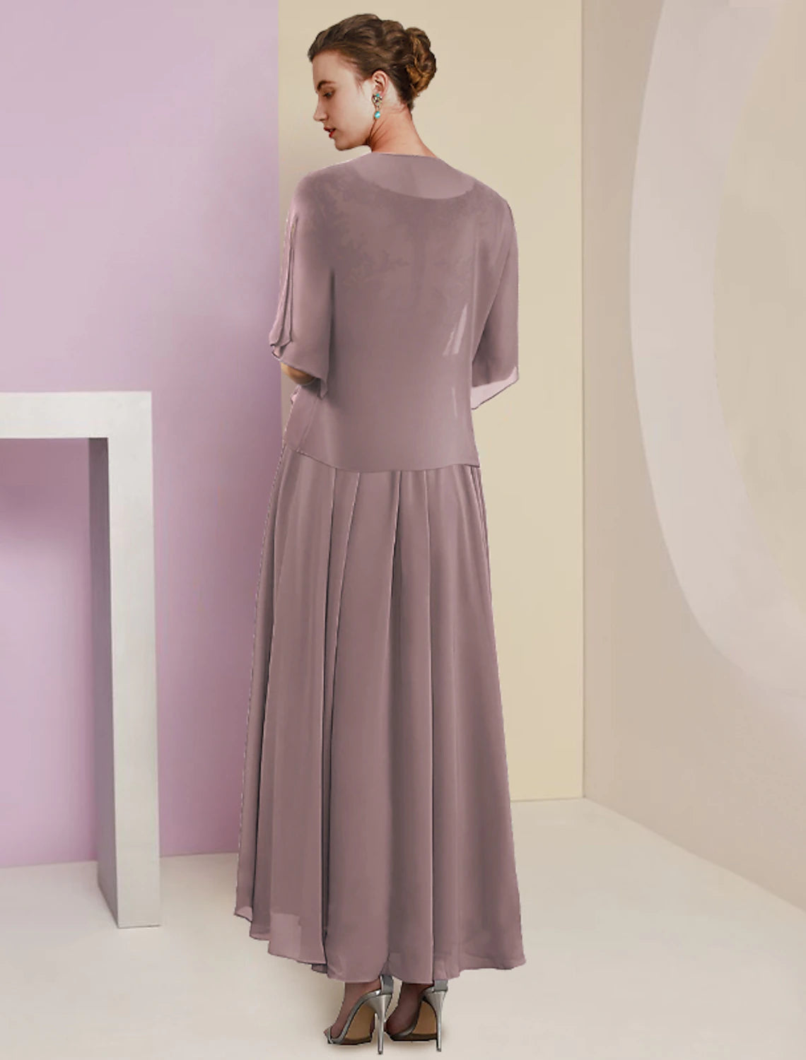 Back view of the flowing A-line skirt and short sleeve jacket of the two-piece dress.