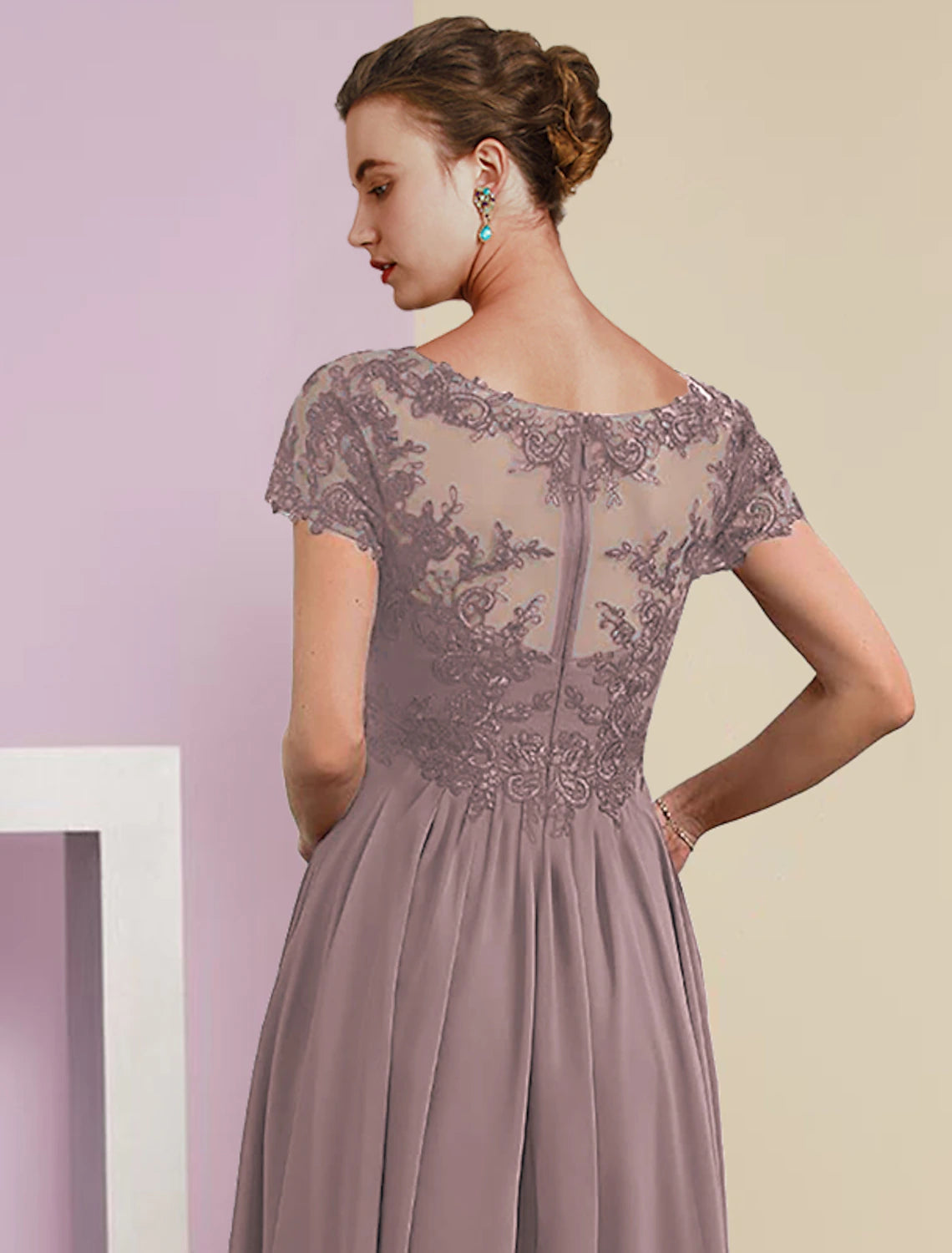 Model posing gracefully in the formal two-piece mother of the bride dress.