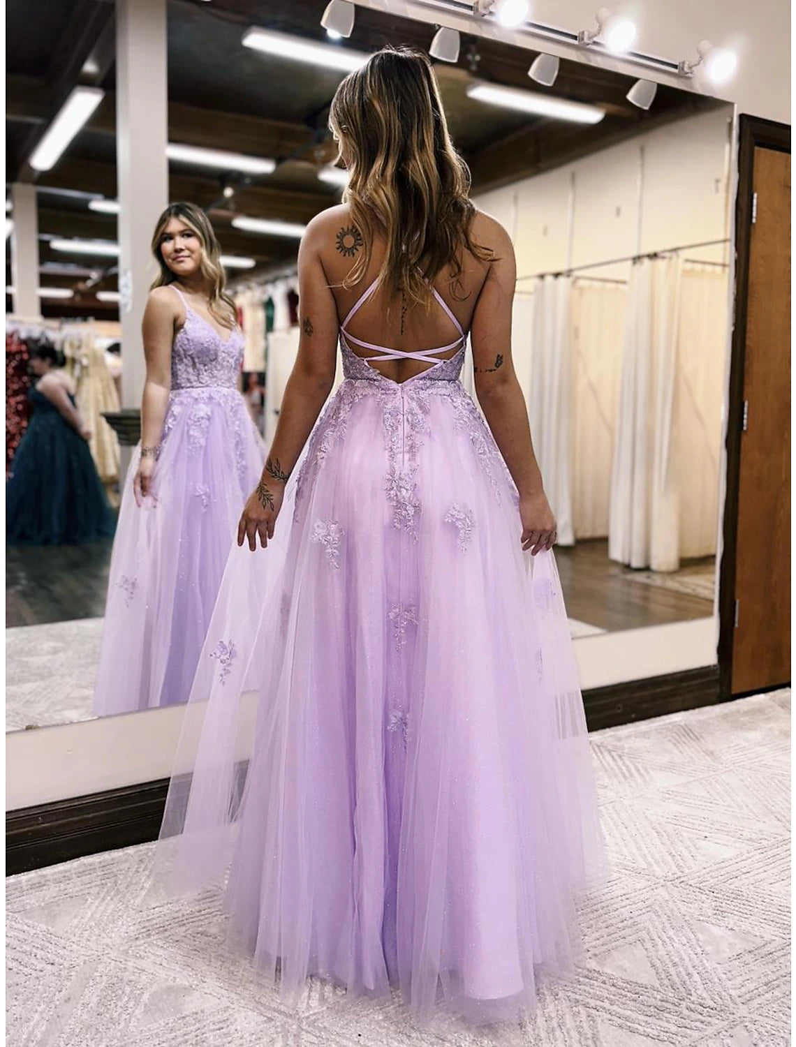 Front view of the A-line V-neck tulle gown, highlighting the beading, appliques, and elegant slit.