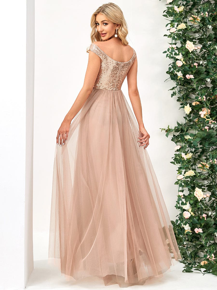 Side view of a model in a rose gold A-line sequin off-shoulder maxi tulle dress.