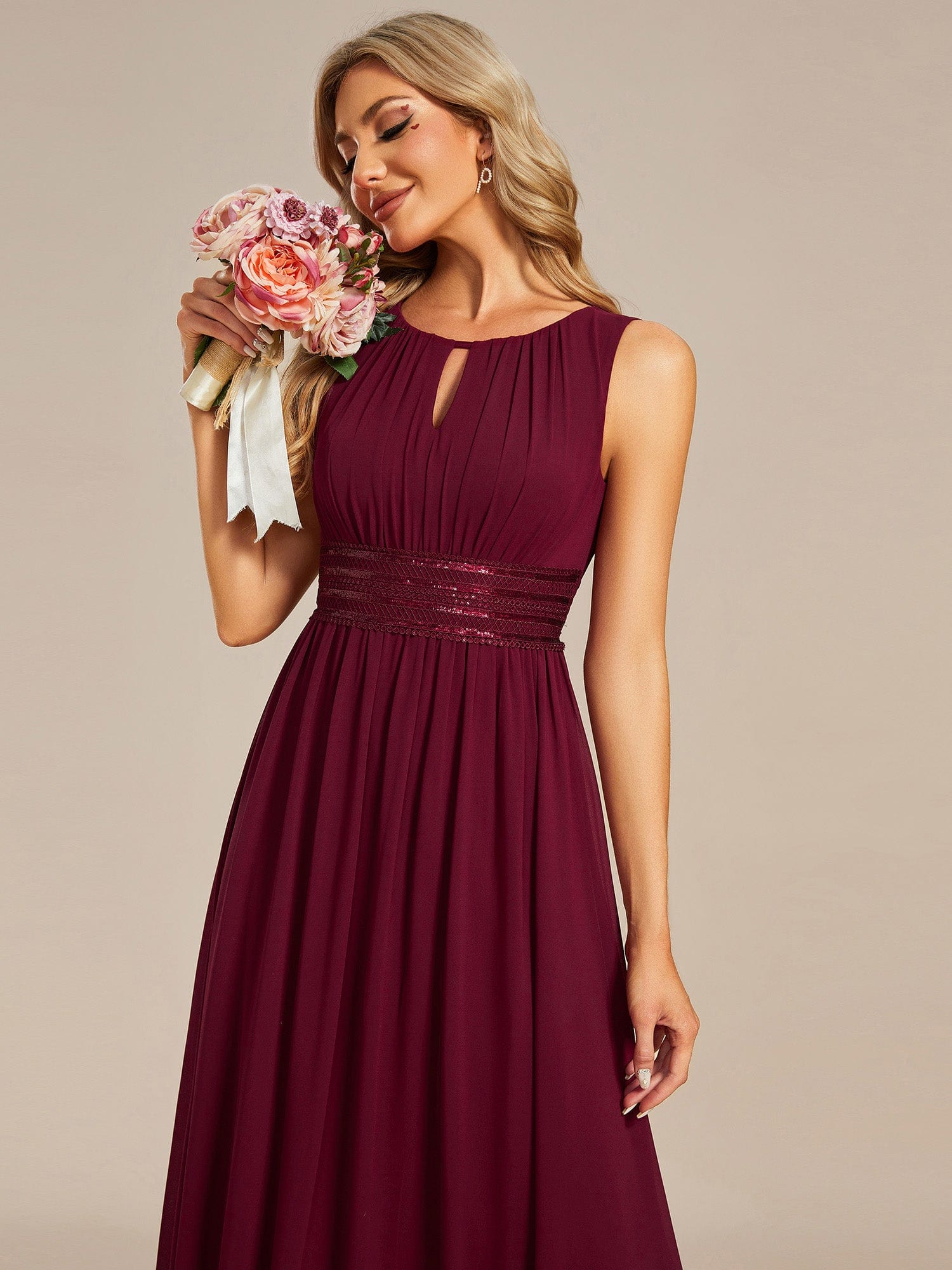Back view of a red A-line sleeveless chiffon dress, highlighting the hollow-out detail.