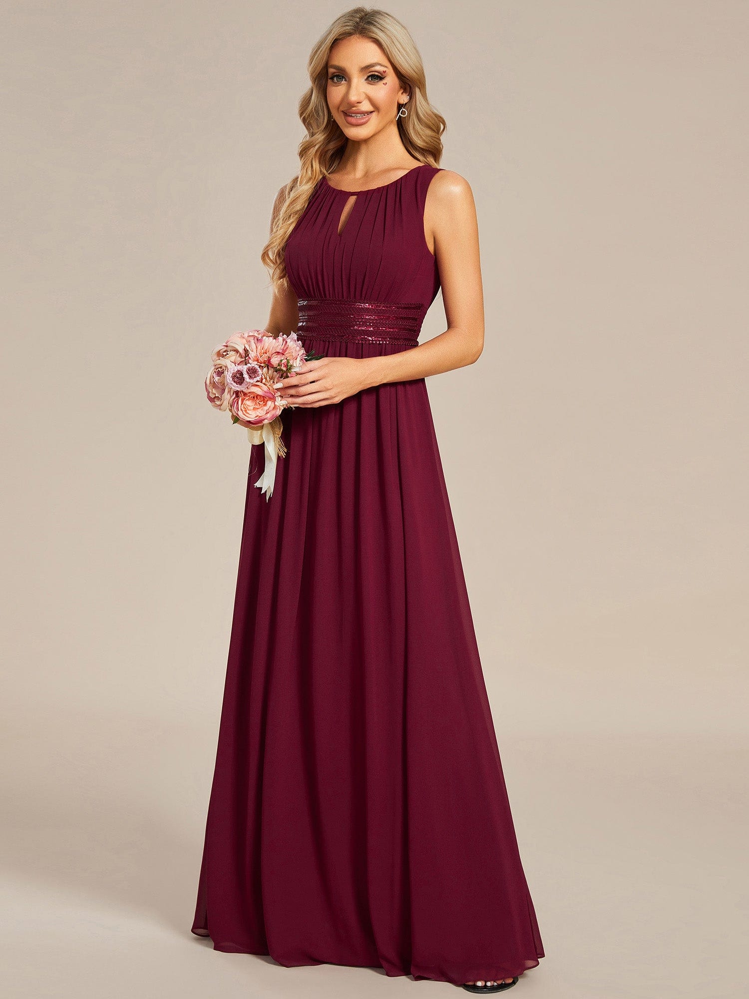 Close-up of the red chiffon fabric and hollow-out detail on the dress.