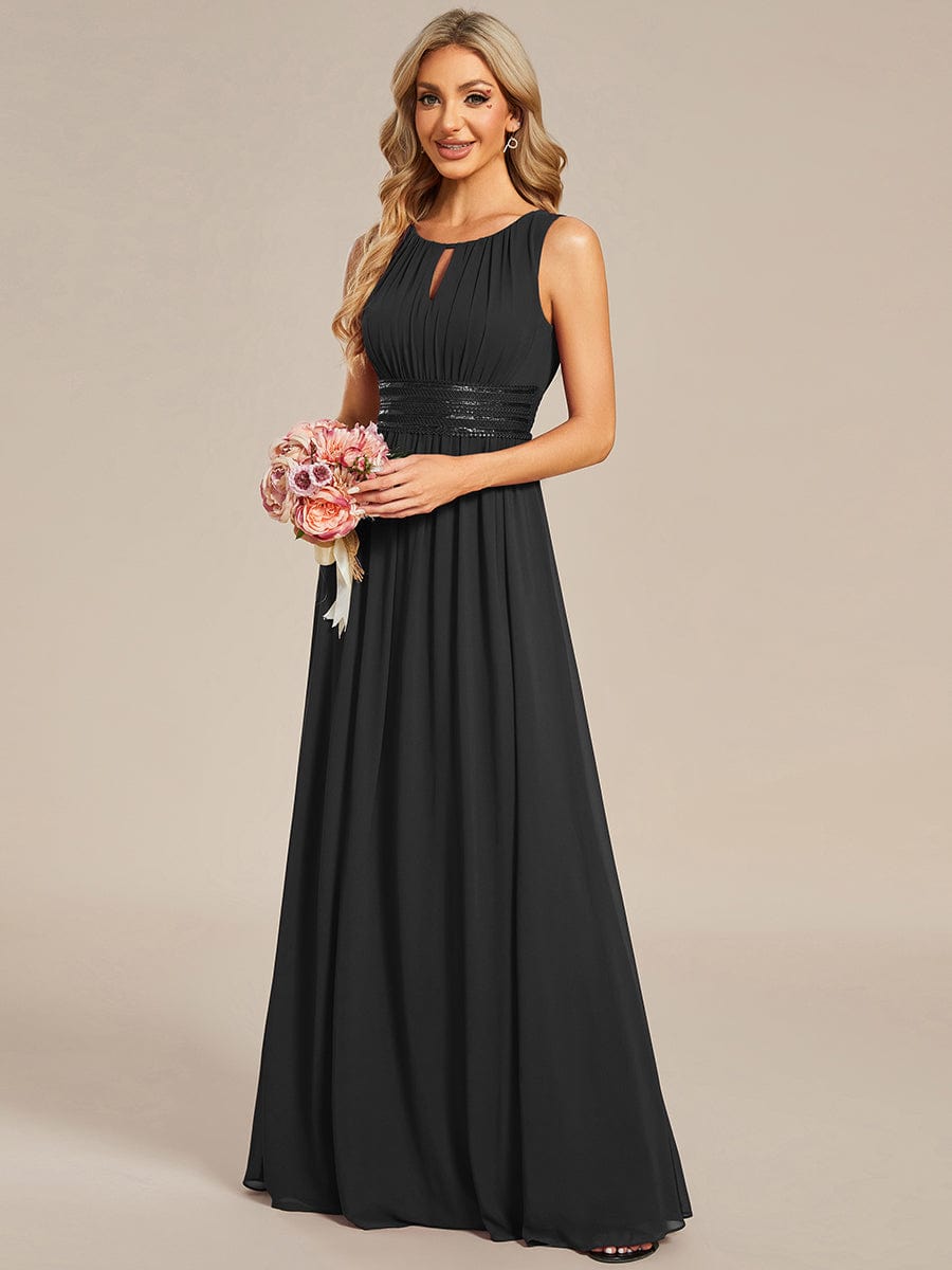 Model wearing a black A-line sleeveless chiffon bridesmaid dress.