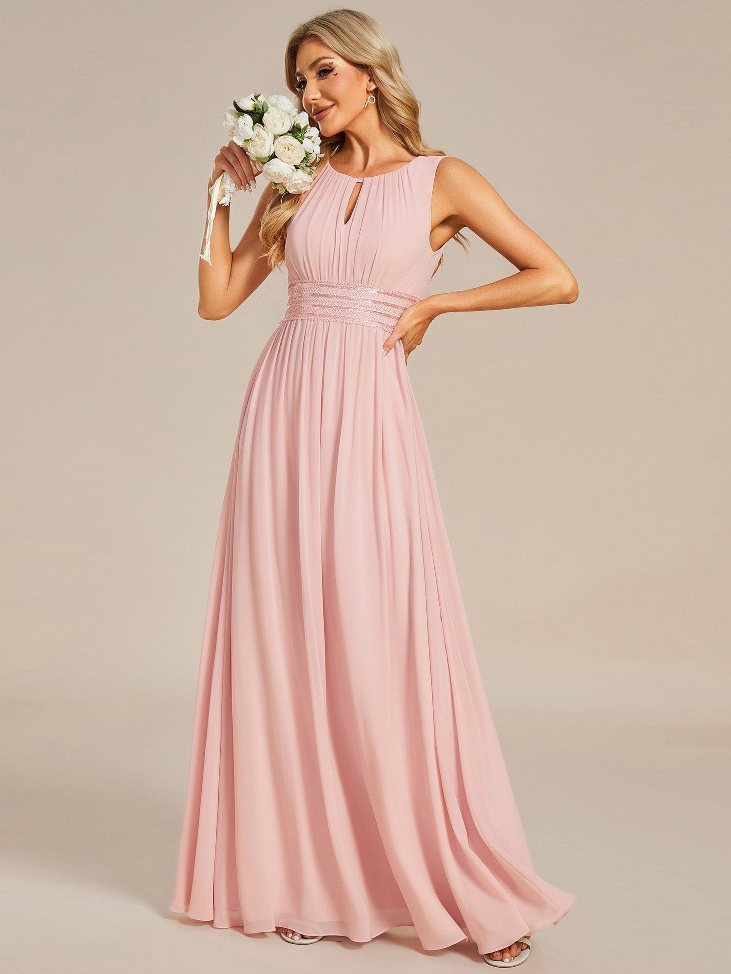 Model wearing a pink A-line sleeveless chiffon bridesmaid dress.
