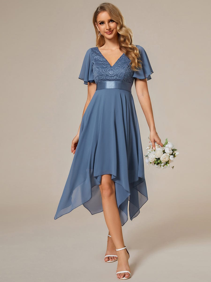 Model wearing a navy Weitese asymmetrical empire waist bridesmaid dress.