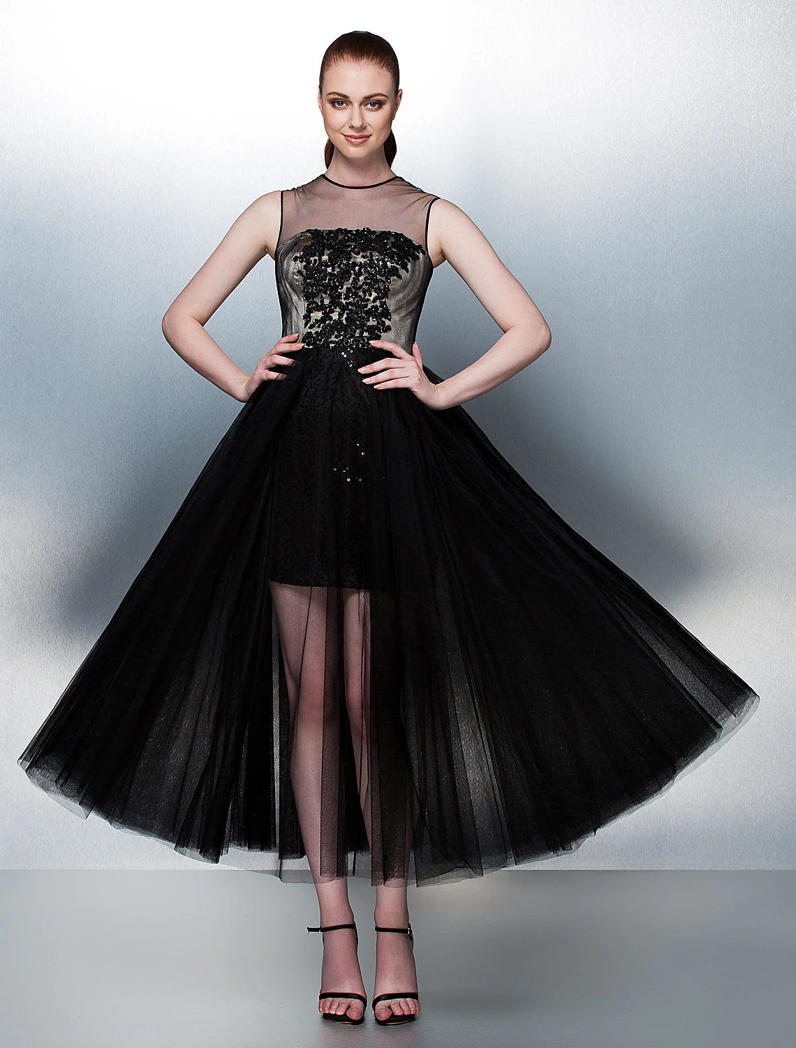 Weitese aqua tea length ball gown with illusion neck and intricate beading.