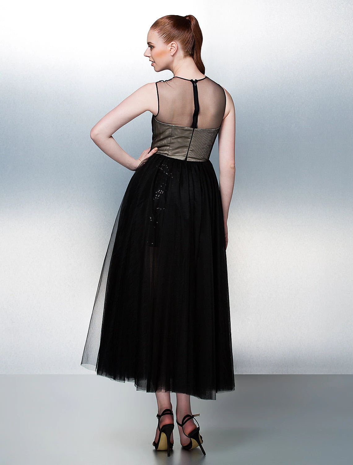 Close-up of the illusion neckline and beaded bodice of the formal dress.