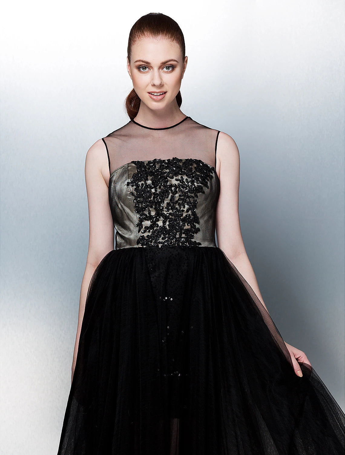 Back view of the aqua formal gown, showcasing illusion back and appliques.
