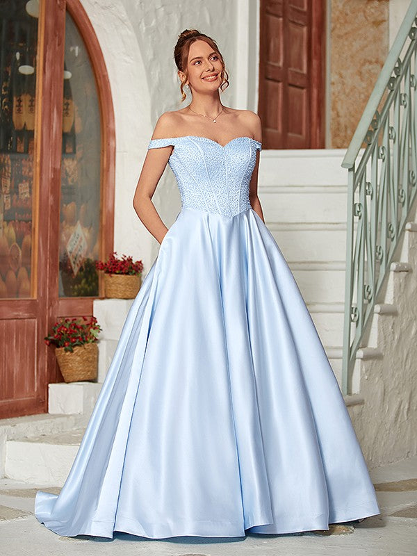 Model wearing an elegant light blue off-shoulder beaded satin ball gown with a sweep train.