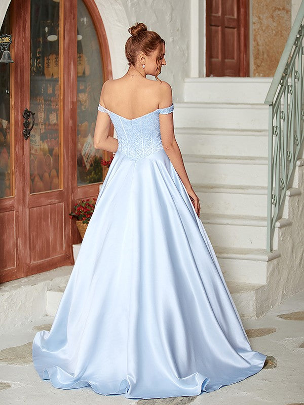 Close-up of the off-shoulder neckline and intricate beading on the light blue satin ball gown.