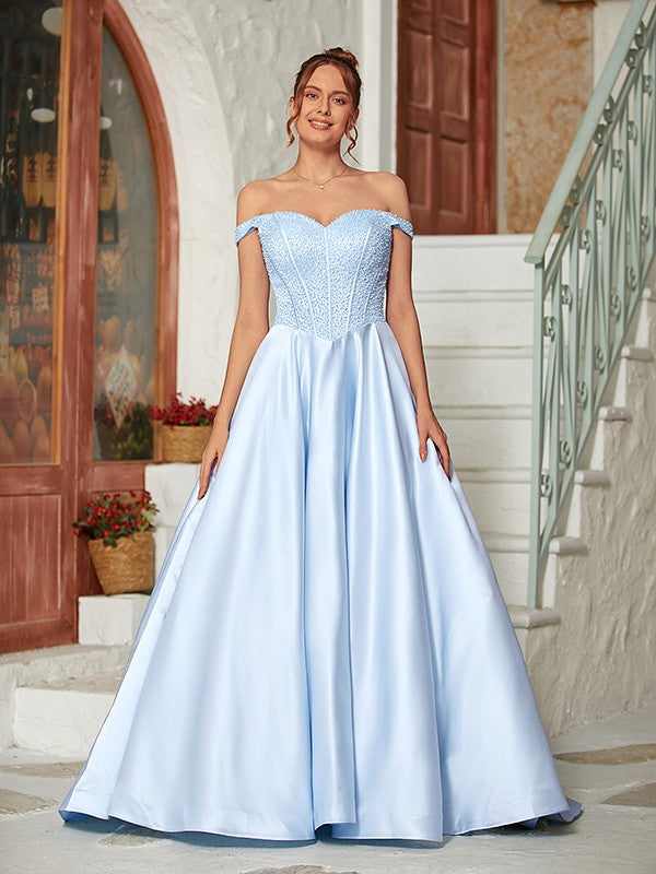 Full-length view of the light blue off-shoulder beaded satin ball gown.