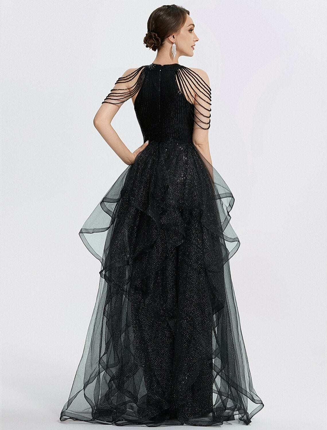 Side view of the black mermaid trumpet dress, highlighting the silhouette and tulle fabric.