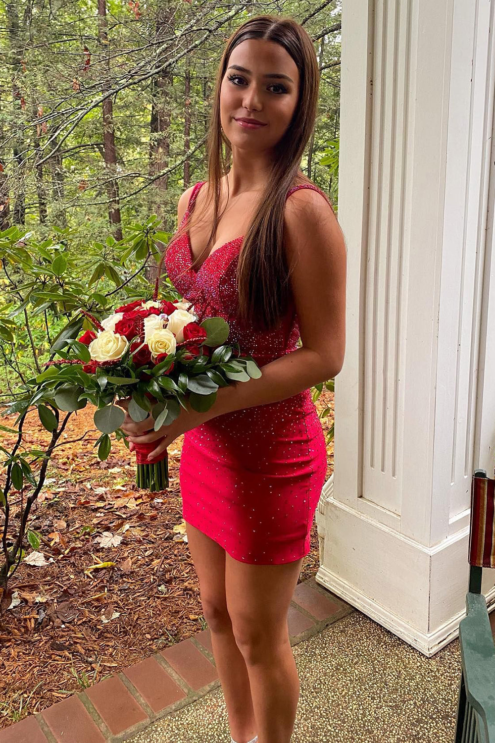 Red sheath homecoming dress with spaghetti straps and beading.