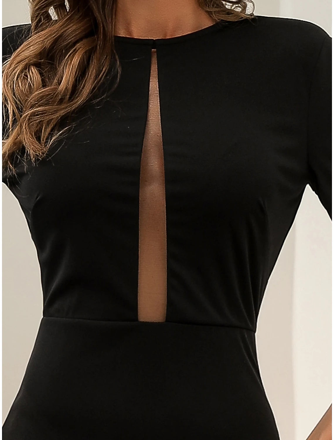 Back view of the black formal gown, showcasing the long sleeves and court train.
