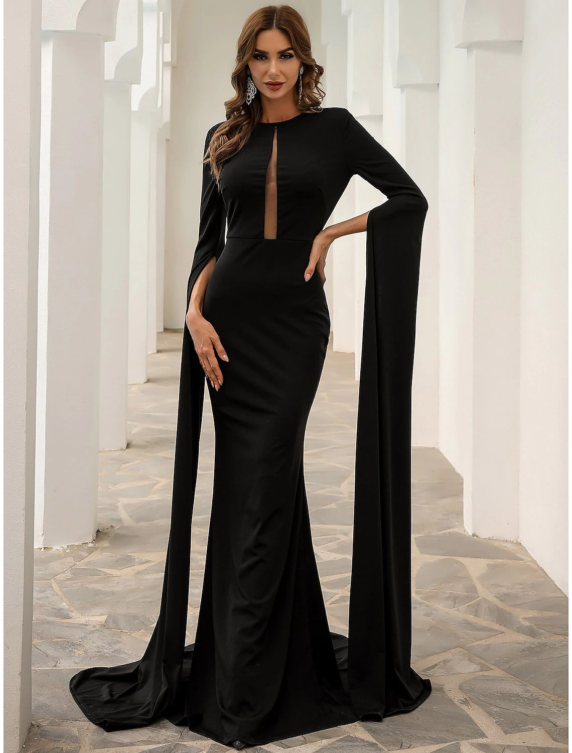 Close-up of the black evening gown's jewel neck and long sleeve detail.