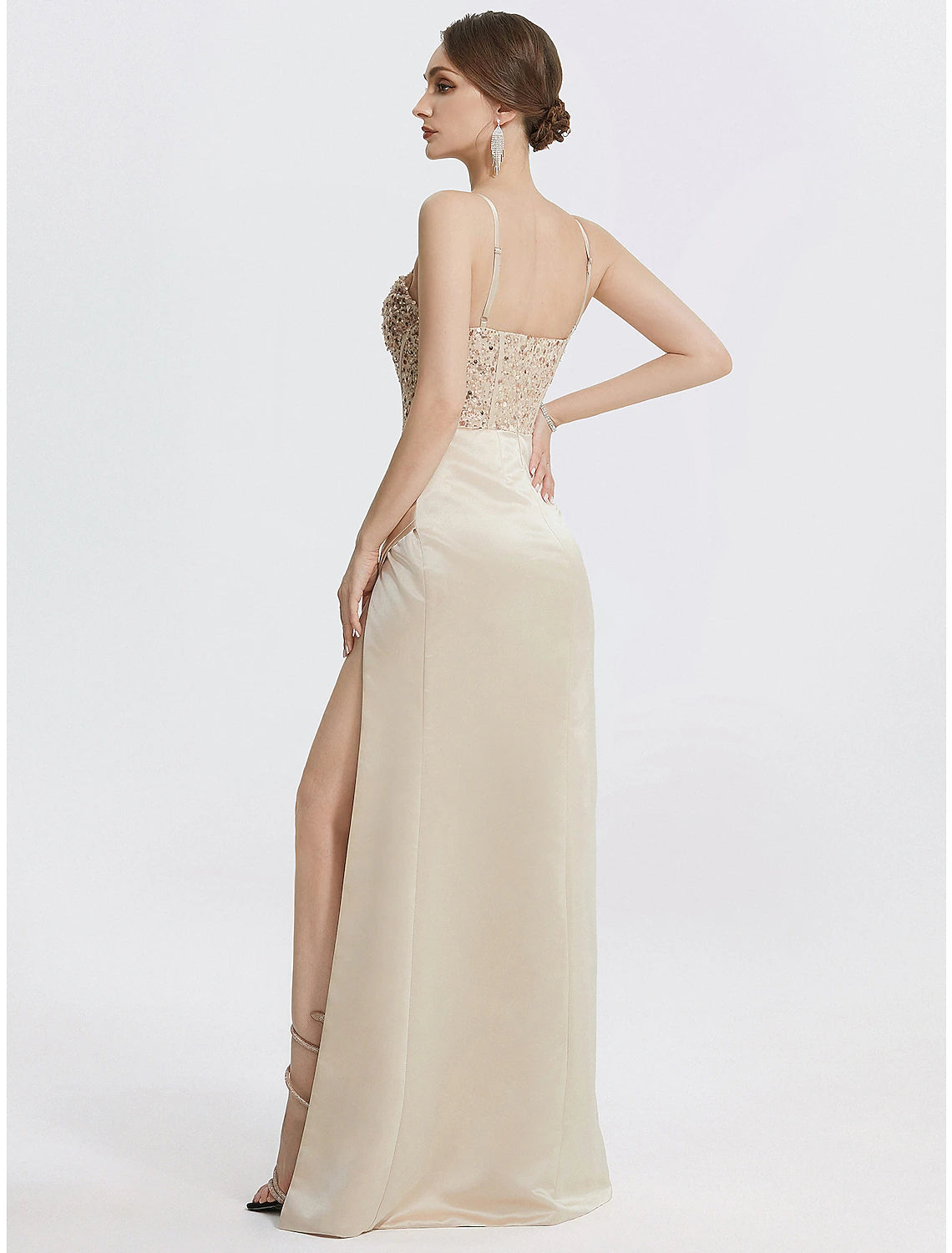 Side view of the black sheath column evening gown, highlighting the silhouette and feather details.