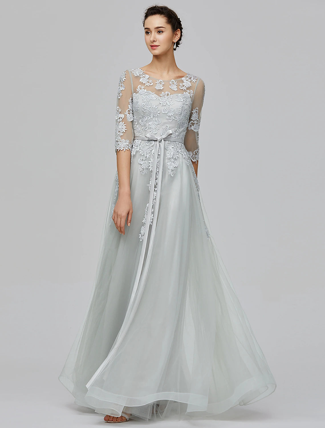 Elegant blush A-line empire gown with illusion neck and half sleeves.