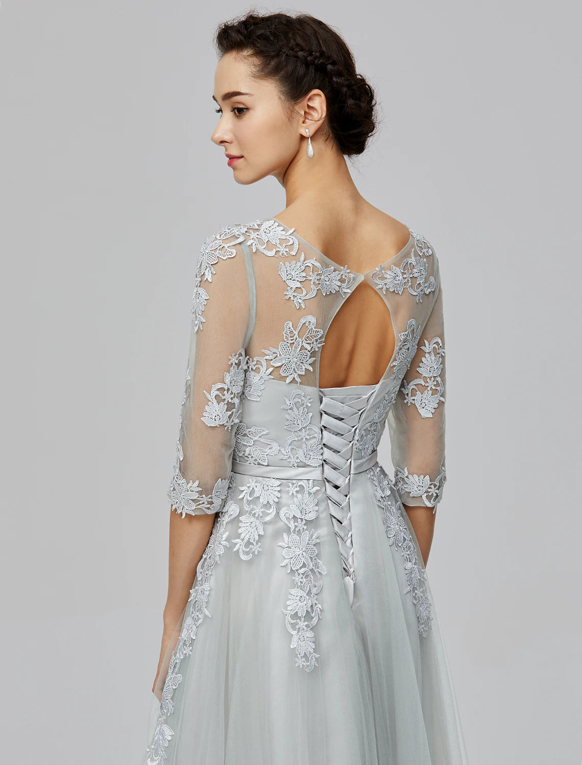 Full length view of a blush A-line empire gown with a flowing tulle skirt.
