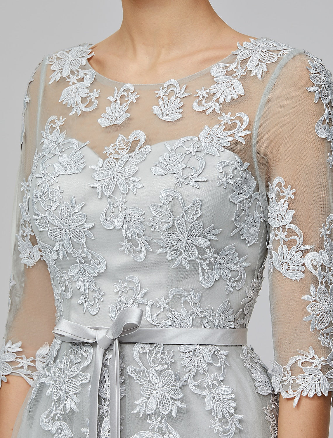 Detailed view of the appliques and bow embellishments on the back of the gown.