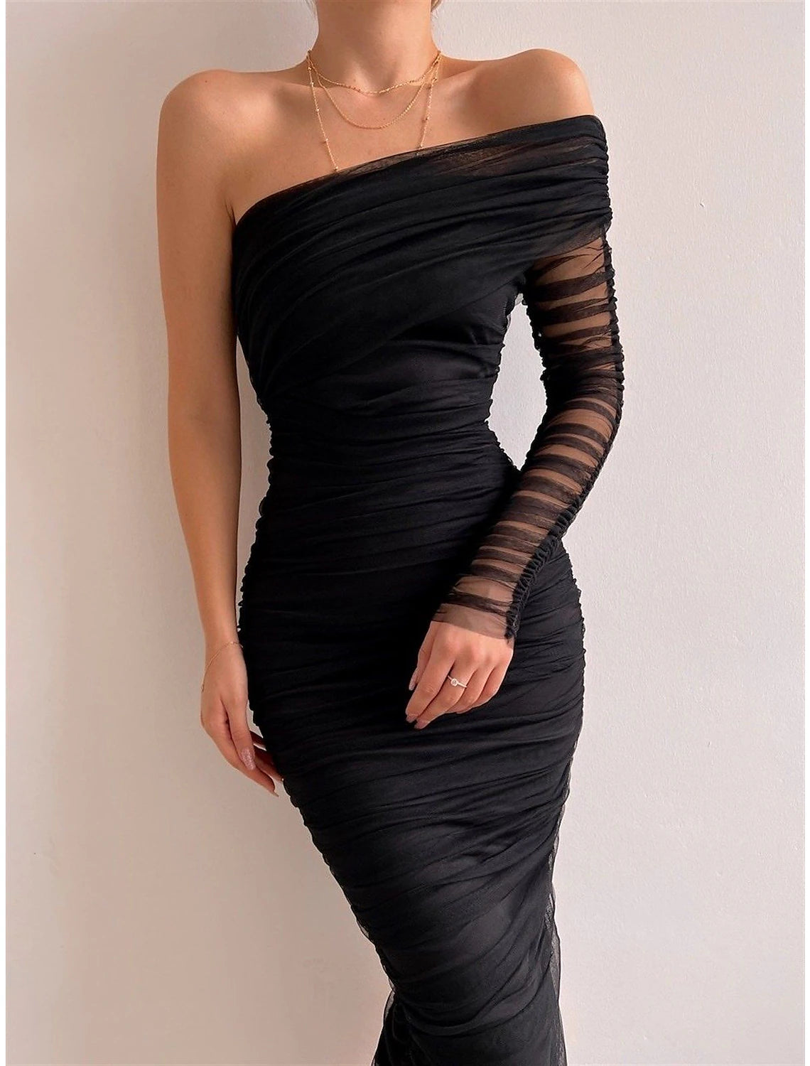 Back view of a black one-shoulder bodycon dress.