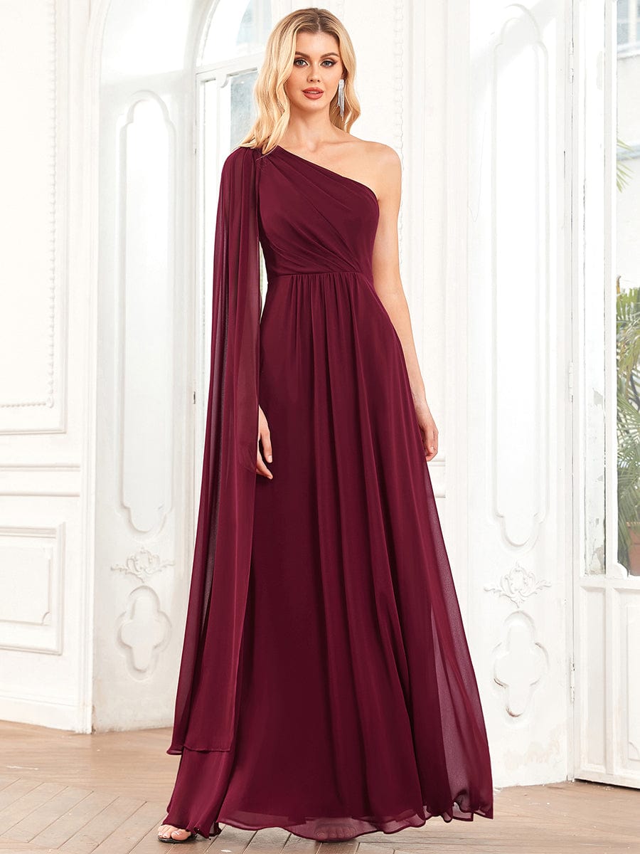 Burgundy A-line bridesmaid dress with asymmetrical sleeve and pleated chiffon.