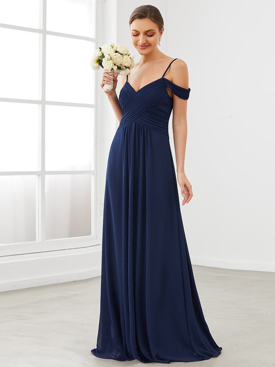 Full view of an elegant navy blue A-line V-neck spaghetti strap bridesmaid dress.