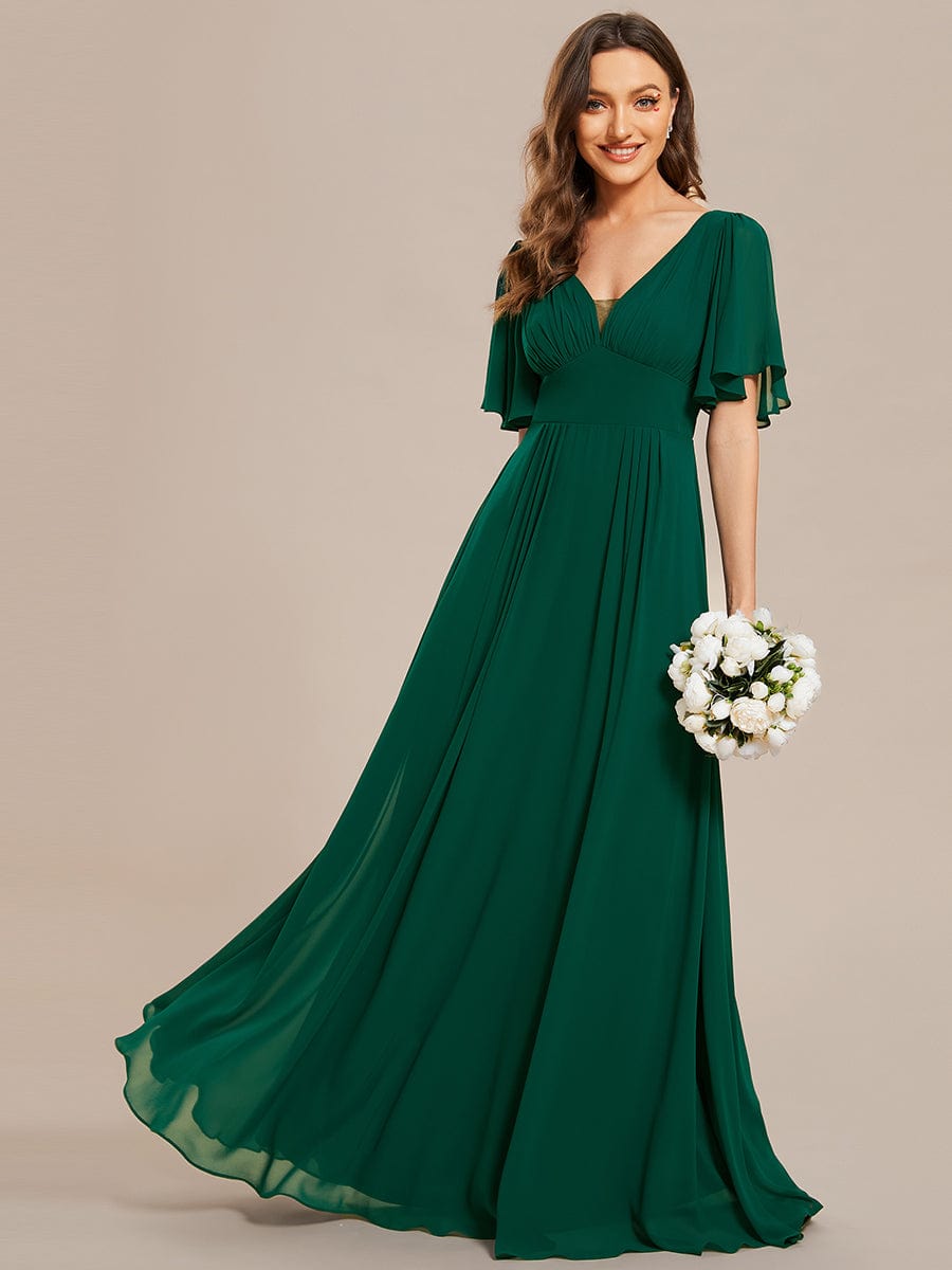 Back view of a model wearing the dark green chiffon A-line maxi dress.