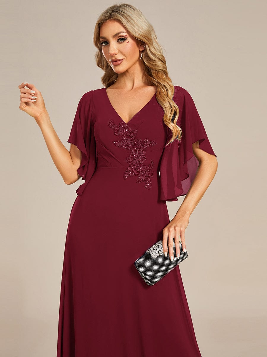 Back view of the blue chiffon formal gown, highlighting the elegant design.
