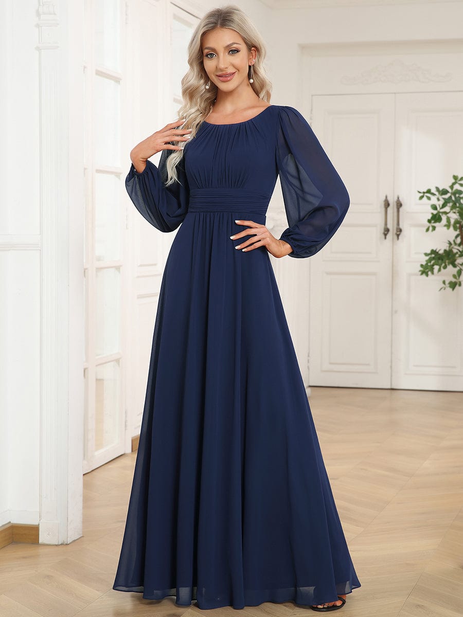 Woman wearing a navy blue Weitese chiffon high empire waist puff sleeve maxi dress.
