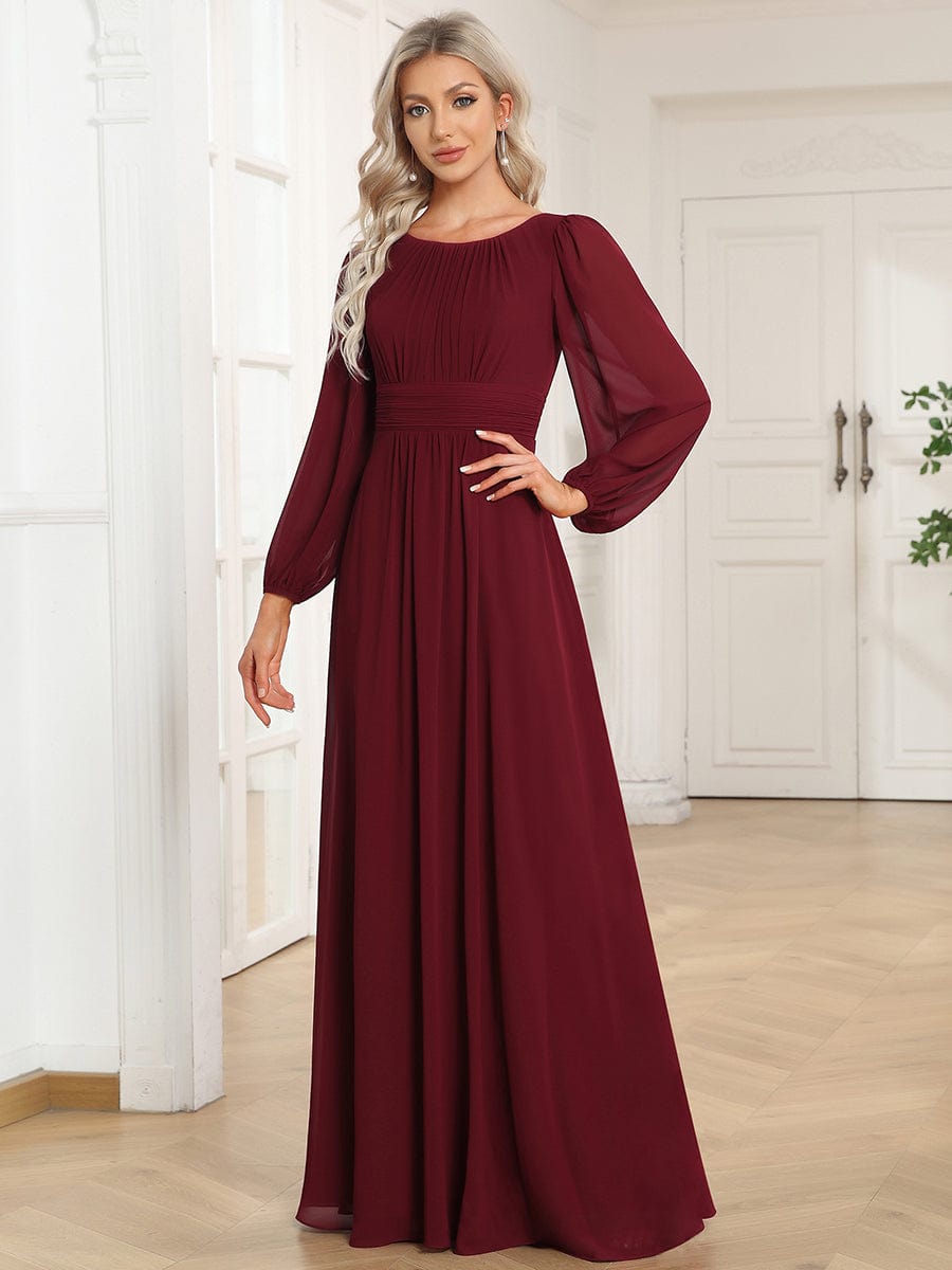 Woman wearing a burgundy Weitese chiffon high empire waist puff sleeve maxi dress.